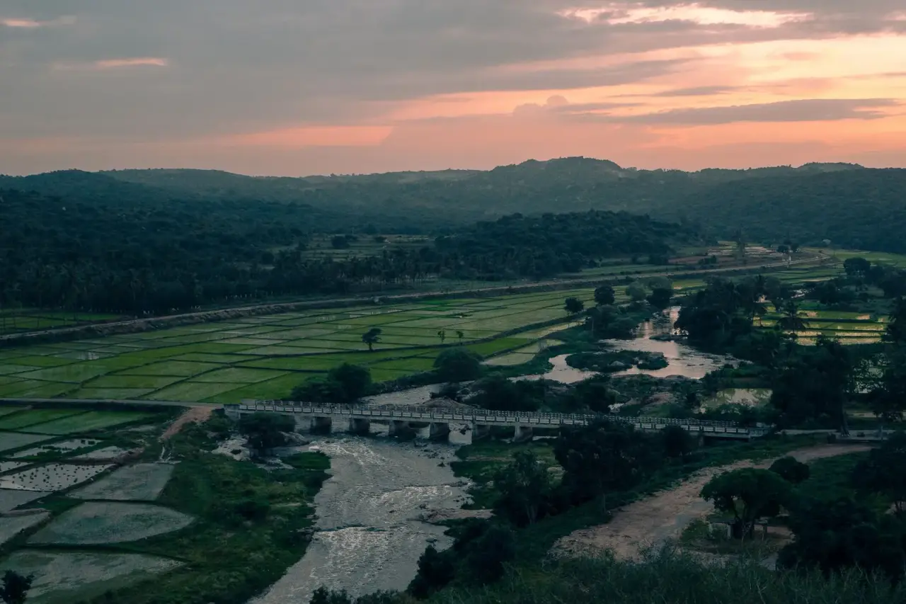 Aerial view of fields and a river near Hosur at sunset