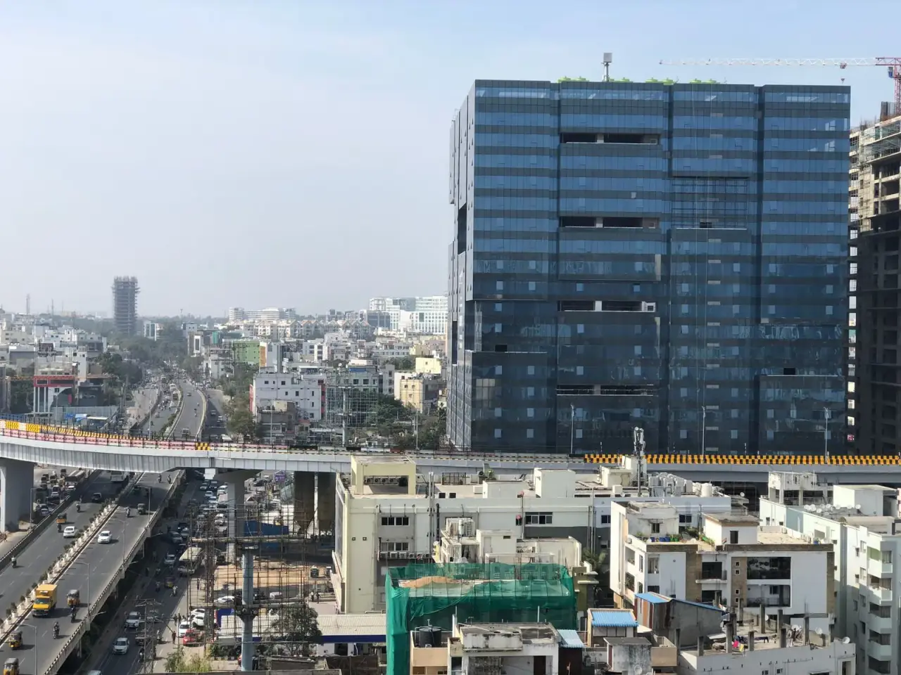 Hyderabad skyline of glass towers beside a flyover
