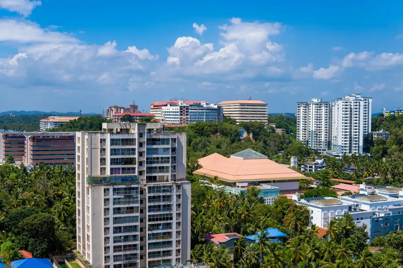 Mangaluru cityscape with palms and high-rise buildings